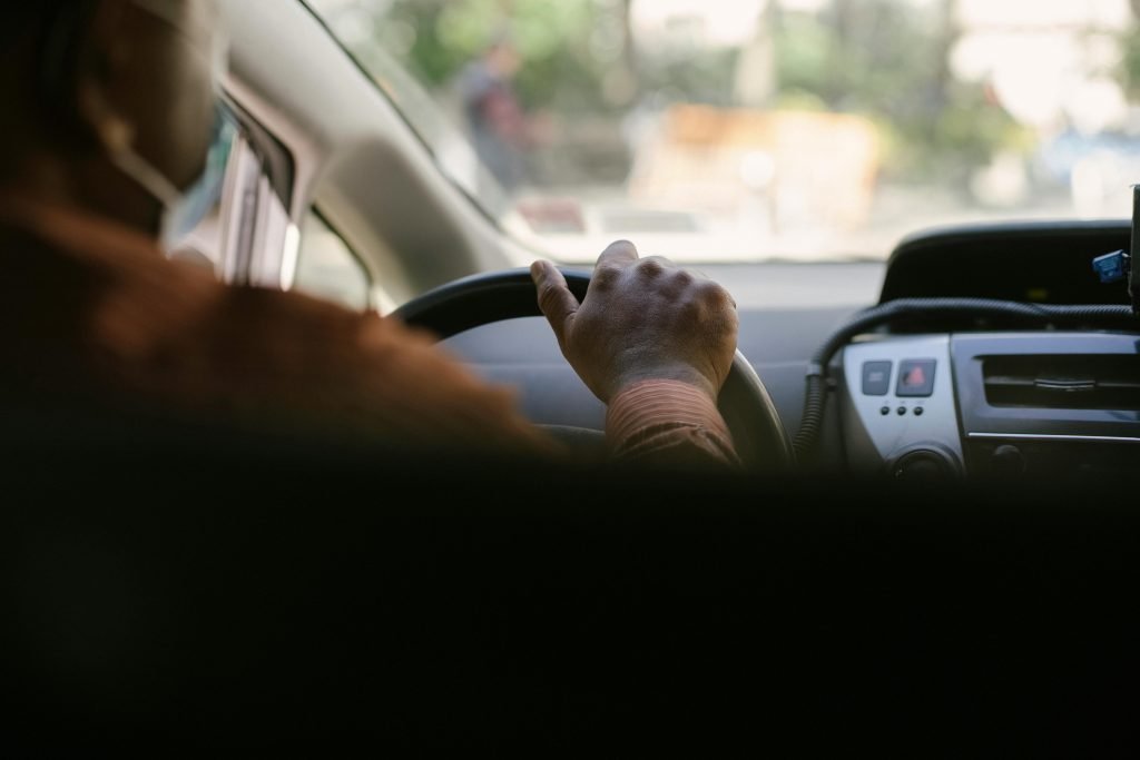a man driving a vehicle in town